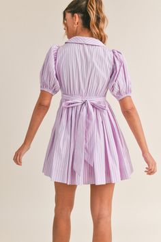 This pinstripe dress features short puff sleeves, a v-neck collared neckline, and a self tie and button front detail. The versatile tie can be styled in the front or the back, giving you different looks for any occasion. Made from high-quality materials, this dress offers both comfort and style. Simple Frocks, Pinstripe Dress, New Tops, Babydoll Dress, Neck Collar, Puff Sleeves, Denim Dress, Pink Dress, Puff Sleeve