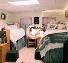 two beds in a room with lights on the ceiling