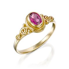 a yellow gold ring with a pink stone in the center and swirl designs around it