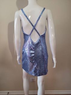 "Inspired by Dua Lipa's song \"Levitating\" It is made with a cornflower blue stretch sequin fabric. 100% lined 4 Rhinestone ornaments on the straps The skirt length from waist to hem is approximately 17\" and about 4\" above the knee (If you would like the skirt a little longer please contact me. Made to Order Sizes: Bust XS- 31-33\" Bust S- 34-36\" Bust M- 37-39\" Bust L- 40-41\" Bust Waist XS- 25-26\" waist S- 27-28\" waist M- 29-30\" waist L- 31-32\" waist Hips XS- 33-34 S- 35-36 M- 37-40 L- Blue Fitted Low Back Dress, Blue Fitted Dress With Low Back, Glamorous Low Back Party Dress, Sequin Stretch Backless Dress, Stretch Sequin Backless Dresses, Blue V-neck Backless Dress For Party, Fitted Sequin Dress With Beaded Straps For Summer, Blue Backless Sequin Dress For Summer, Backless Blue Sequin Dress For Summer