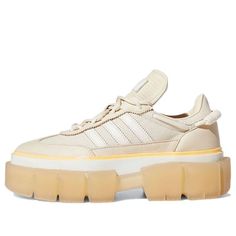 Get a fashion-forward look with the Ivy Park x adidas Women's Super Sleek 'Halo Ivory' Sneakers. These stylish sneakers are developed in coordination with Beyoncé's athleisure brand, Ivy Park, and feature a beige textile upper with tonal leather overlays. A dynamic lacing system with a coiled paracord at the heel provides a secure fit, while Ivy Park branding on the insole and a peach-colored stripe wrapped around the raised rubber foxing add a touch of style. The sneaker is mounted on a semi-tr Adidas Lace-up Platform Sneakers For Streetwear, Adidas Platform Sneakers With Rubber Sole For Streetwear, Adidas Platform Sneakers With Vulcanized Sole For Streetwear, Sporty Cream Platform Sneakers With Contrast Sole, Cream Platform Sneakers With Contrast Sole, Adidas Platform Sneakers With Boost Midsole For Streetwear, Adidas Sporty Platform Sneakers With Translucent Outsole, Adidas Sporty Platform Sneakers For Streetwear, Adidas Sporty Platform Sneakers With Rubber Sole