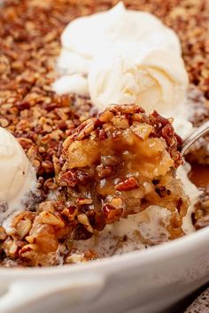 a close up of food in a bowl with ice cream and pecans on top