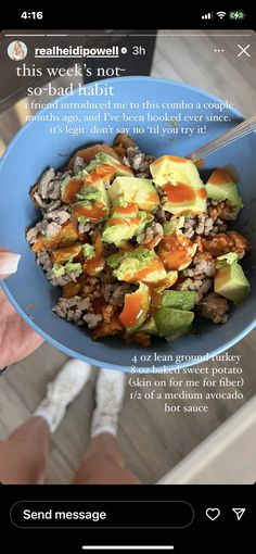 someone is holding a bowl of food with avocado and other things in it