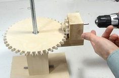 a person using a drill to work on a piece of wood