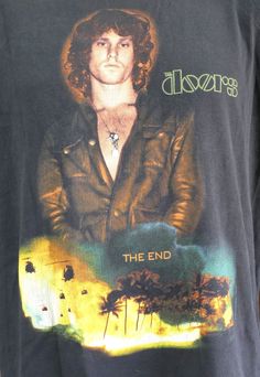 a man wearing a black shirt with an image of the band blonds on it