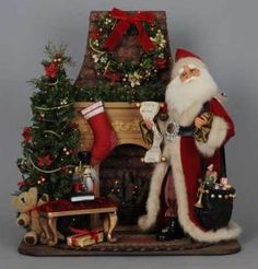 a santa claus figurine sitting next to a fireplace with christmas decorations on it