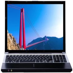 an open laptop computer sitting on top of a wooden table next to a red bridge