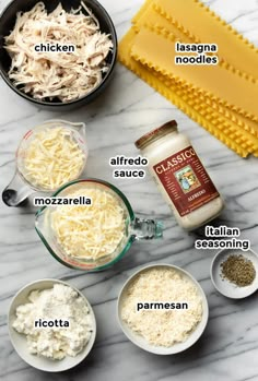 ingredients to make chicken parmesan casserole laid out on a marble counter