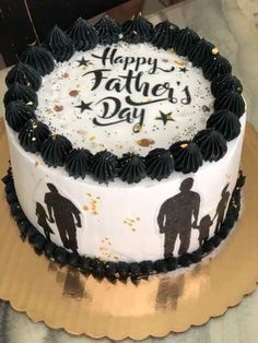 a white and black cake with the words happy father's day written on it