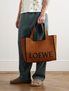 Made in Spain using raffia that's harvested and woven in Madagascar by local artisans, Loewe's tote bag is embroidered with the brand's logo and edged with a contrasting trim. Made in collaboration with Paula’s Ibiza, it's generously sized to hold a tablet, towel and water bottle and fitted with internal leather slots for securing smaller items. Tote Bag For Men, Raffia Tote Bag, Contrasting Trim, Local Artisans, Spring Shoes, Suede Jacket, Formal Shirts, Knitted Bags, Weekender Bag