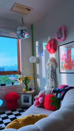 a living room filled with furniture next to a window covered in colorful balloons and decorations