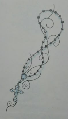 a drawing of a cross with beads on it