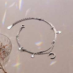 If you're looking for a beautiful and meaningful way to inspire your granddaughter to reach for the stars, this bracelet is a perfect choice. The delicate crescent moon and shining star charms represent new beginnings, hope, and guidance from the universe. Whenever she wears it, she'll be reminded that she can achieve anything she sets her mind to. Whether she's just starting kindergarten, graduating from college, or just needs a little extra motivation, this bracelet is sure to be cherished for Celestial Sterling Silver Bracelets, Sterling Silver Bracelets With Moon Charm, Sterling Silver Bracelet With Moon Charm, Celestial Silver Charm Bracelet, Dainty Sterling Silver Bracelet With Star Charm, Silver Celestial Bracelet With Star Charm, Sterling Silver Moon Phase Bracelet For Gift, Sterling Silver Moon Phase Bracelet As Gift, Celestial Silver Bracelet With Star Charm