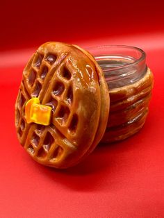 two waffles sitting on top of each other next to a jar of peanut butter