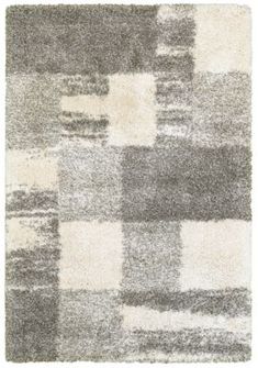 an area rug with grey and white squares on it