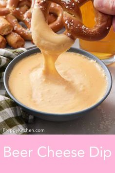 a pretzel being dipped with beer cheese dip