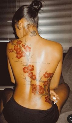 the back of a woman's body with flowers on it