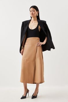 Experience Updated Wardrobe Essentials With Our Midi Skirt, Made In Sleek Faux Leather, Featuring A Flared Silhouette And A High Waistline, Creating A Universally Flattering Fit. With A Statement Wrap Style, This Piece Can Be Styled With With Anything To Create A Look With Impact, From A Blouse And Strappy Heels, To A Knit Jumper, Tights, And Boots. Faux Leather Tie Detail Wrap Midi Skirt High Quality Faux Leather Fabric Statement Wrap Style Comfortable High Waistline Flattering Full Silhouette Skirt Collection, Wrap Midi Skirt, Lace Sleeve Top, Striped Midi Skirt, Leather Tie, Linen Shirt Dress, Faux Leather Fabric, Stripe Skirt, Karen Millen