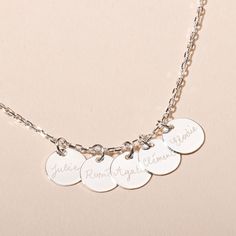 Inspired by the strong family bond, our Personalised 4 &amp; More Necklace is made up of delicate charms, all hand-engraved with the names of the ones you love. The perfect piece for those with multiple children.18K Champagne Gold Plated or 925 Sterling SilverCharm size: 1cm Diameter, 0.05cm ThicknessSecure clasp fasteningCharms are removable from this chain and can be worn on all Merci Maman chain lengthsHand engraved in our Paris workshopSent with love in a complimentary gift boxAny slight Sterling Silver Name Necklace With Engraving Option, Sterling Silver Pendant Name Necklace With Engraving, Silver Sterling Name Necklace With Engraving Option, Sterling Silver Nameplate Charms Jewelry, Silver Nameplate Necklace With Charms, Sterling Silver Nameplate Necklace With Charms, White Gold Sterling Silver Name Necklace With Hallmarks, Sterling Silver Name Necklace With Charms Pendant, Personalized White Gold Round Pendant Charm