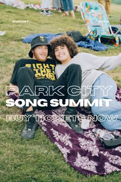 two people sitting on a blanket in the grass with text park city song summit buy tickets now