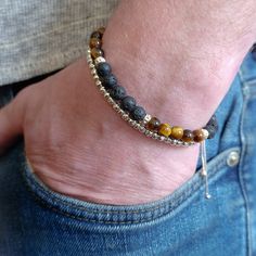 Tiger's Eye and Black Lava Rock men's sterling silver bracelet stack set of two - features a set of two stacking bracelets for men.  The first bracelet is the Tiger's Eye and Black Lave Rock Slider bracelet.  This handcrafted beaded bracelet is strung on a sterling silver chain with genuine tiger's eye, black lava rock and sterling silver cuff beads.  The beads are approximately 6mm in size.  The second bracelet is the Men's sterling silver slider bracelet.  This bracelet is strung with 925 ster Adjustable Sterling Silver Bracelets For Layering, Adjustable Natural Stones Bracelets For Layering, Masculine Silver Jewelry Gift, Masculine Adjustable Silver Jewelry, Adjustable Masculine Silver Jewelry, Masculine Silver Bracelets As A Gift, Sterling Silver Stacking Bracelets, Mens Sterling Silver Bracelets, Men Stone Bracelet