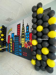 some black and yellow balloons are hanging on the wall