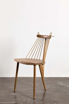 a wooden chair sitting on top of a cement floor