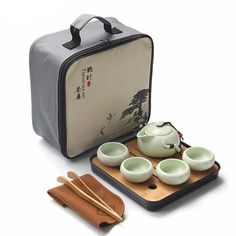 a tea set with four cups and chopsticks in front of a case on a white background