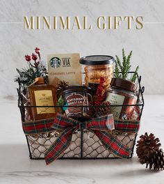 a christmas gift basket with cookies, jams and pine cones