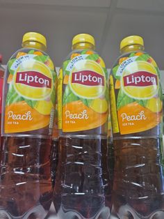 three bottles of lipton peach tea on display