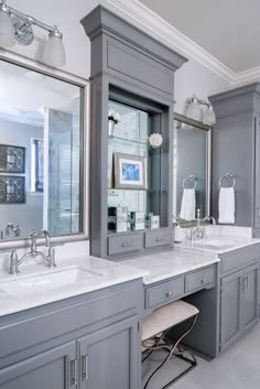 a large bathroom with two sinks and mirrors