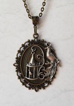 This necklace on a bronze bezel frame is sort of Goth, sort of Victorian. It's done on a bronze bezel setting and has an added decorative jewelry bail. It's a 40x30mm bronze-toned metal bezel setting. I have placed a silver-toned metal ornate birdcage charm in the center and a pretty silver-toned metal bird charm off to one side. The birdcage is 3d and has a tiny bird in it. The charms were affixed with strong adhesive. It's a pretty necklace. And sure to get you noticed. Lol. The charms, findin Cage Necklace, Spider Pendant, Types Of Prayer, The Birdcage, Fantasy Necklace, Jewelry Victorian, Caged Necklace, Pretty Necklace, Tiny Bird