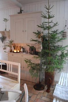 there is a small christmas tree in the kitchen