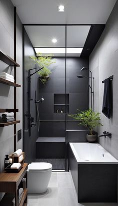 a modern bathroom with black and white walls, flooring, and a plant in the corner