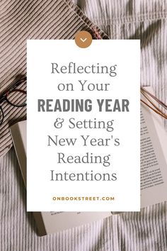 an open book with glasses on top and the words reflecting on your reading year & setting new year's reading intentionss