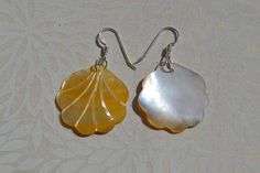 This beautiful earrings feature a carved yellow Mother of Pearl Scallop Shell. . The iridescence of the Mother of Pearl is really amazing. Depending on the light source they will radiate colors varying from yellows to creamy whites with flashes of pinks. The shells are then polished to a high gross to reveal the beauty of their natural pattern. The perfect way to complete your beach outfit and everyday wear. DETAILS - Shell types : Mother of Pearl - Material: Sterling Silver Ear Wire and Jump Ri Gold Shell-shaped Jewelry With Matching Earrings, Handmade Mother Of Pearl Shell-shaped Earrings, White Shell-shaped Mother Of Pearl Earrings, Yellow Gold Shell-shaped Earrings, Gold Plated Shell-shaped Earrings, Island Jewelry, Beach Earrings, Hawaiian Jewelry, Scallop Shells