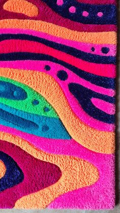 a colorful area rug with an abstract design on the front and back side in bright colors