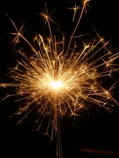 a sparkler is shown in the dark with lots of lightenings on it