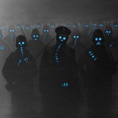 the silhouettes of people with glowing blue eyes are standing in front of a foggy background