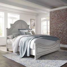 a white bed sitting on top of a wooden floor