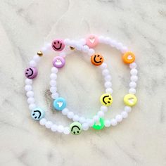 Kids Hearts or Smilies Rainbow Stretch Bracelet Choose your size and your accent charm (heart or smiley)  All beads are acrylic Listing is for ONE bracelet but you can add more than one to your cart.  ** Contact me if you have any questions! ** Rainbow Bracelet Clay Beads, Playful Heart-shaped Letter Beads Bracelet, Trendy White Plastic Bracelets, Trendy White Plastic Bracelet, Playful White Plastic Jewelry, Trendy White Charm Bracelet With Round Beads, Playful Stretch Bracelet With Smiley Face For Gift, Playful Smiley Face Stretch Bracelet As Gift, Fun Plastic Jewelry For Friendship