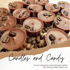 candles and candy with coffee beans in them on a wooden table next to a card that says candles and candy