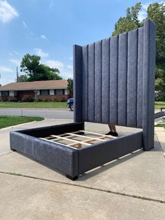 a bed frame sitting in the middle of a sidewalk