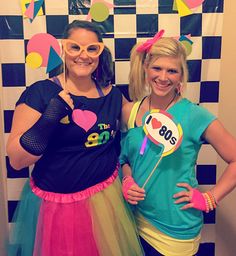 two women dressed up in costumes posing for the camera