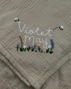 a quilt with embroidered words and flowers on it that says votet may in white letters