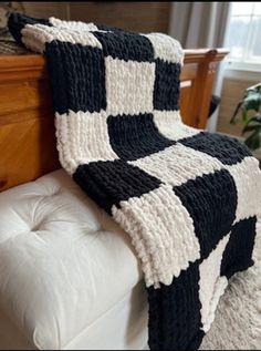 a black and white blanket sitting on top of a couch