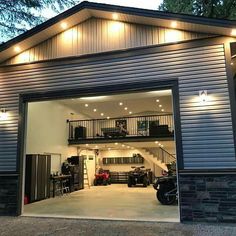 an open garage door with lights on the side and stairs leading up to the second floor