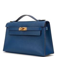 This Mini Kelly Pochette is in Deep Blue swift leather with gold hardware and has tonal stitching, front flap, two straps with center toggle closure and a top flat handle. The interior is lined with Deep Blue chevre and has an open wall pocket. Collection: D Origin: France Condition: - Mint; the bag retains its structure. The leather shows very light signs of use. The hardware is covered with slight scratching to the turn lock. The inside is clean with no wear. Accompanied by: Hermes box, Hermes dustbag, felt, carebook Measurements: 8.5" width x 5" height x 2.5" depth; 1" top handle Hermes Kelly Pochette, Kelly Pochette, Mini Kelly, Open Wall, Ysl Shoes, Jimmy Choo Sunglasses, Hermes Shoes, Hermes Box, Fendi Shoes