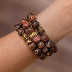 Add a touch of nature to any outfit with this unique stack of beaded bracelet designed and handmade in the South featuring semi-precious gemstones and gold accents. Each stack is carefully put together with perfect color combinations to accent the stones best features. Pair it with jeans and your favorite top for all day style. One size fits most. Stretches slightly for a comfortable fit. Handmade in Jacksonville, Florida Each of our designs are hand crafted and may vary slightly. Gold Spiritual Beaded Bracelets Hand Wrapped, Gold Agate Bracelet With Gemstone Beads, Earthy Beaded Bracelets With Natural Jasper Stones, Earthy Jasper Beaded Bracelets With Natural Stones, Earthy Jasper Beaded Bracelet With Natural Stones, Gold Bracelets With Natural Round Beads, Gold Bracelets With Round Natural Stones, Elegant Wrap Bracelet With Round Natural Stones, Rondelle Natural Stones Beaded Bracelets For Healing