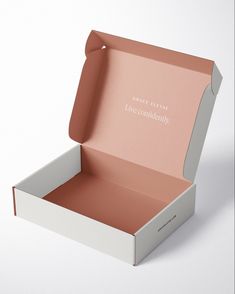 an open white box with pink interior and writing on the inside that says once always live comfortably